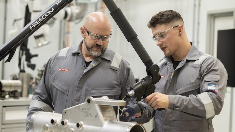 Two men operating machinery