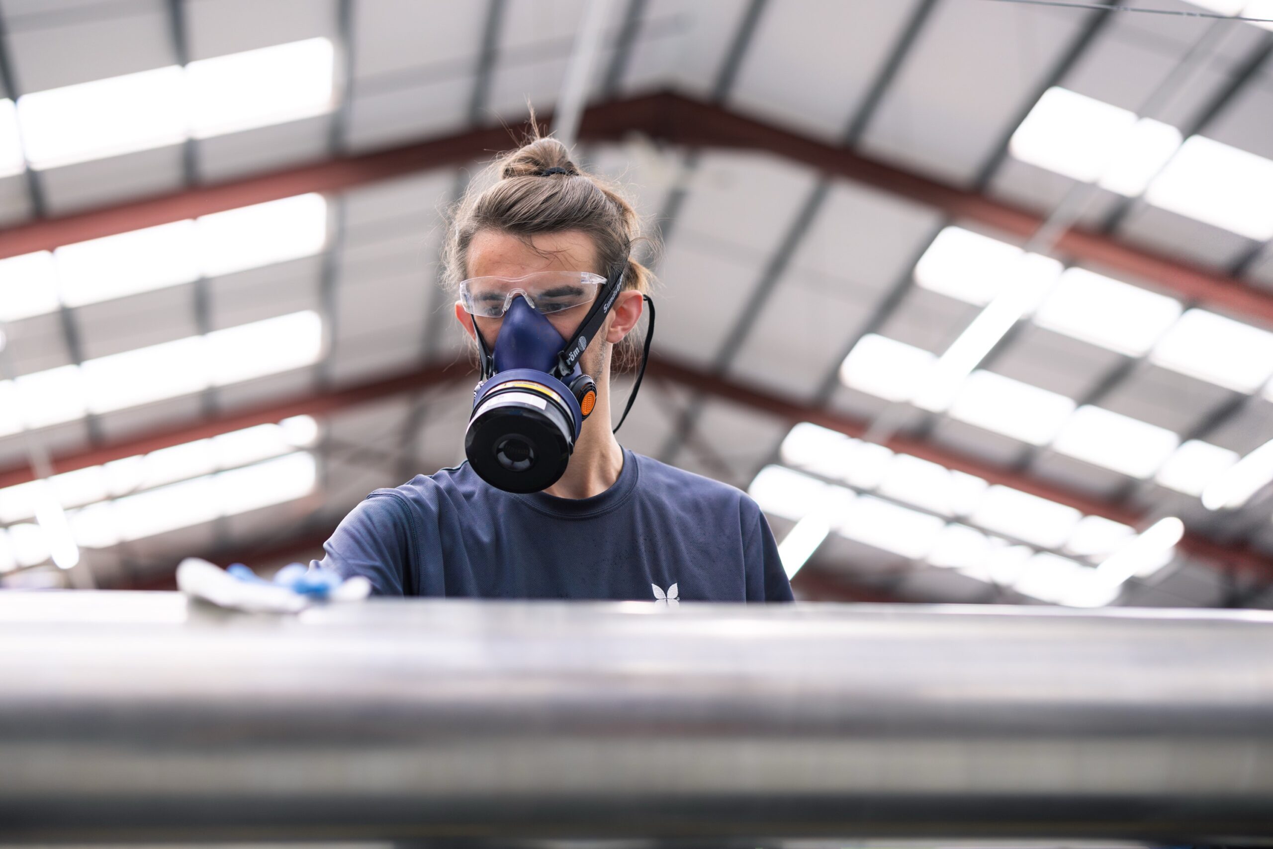 Young man working in defence factory